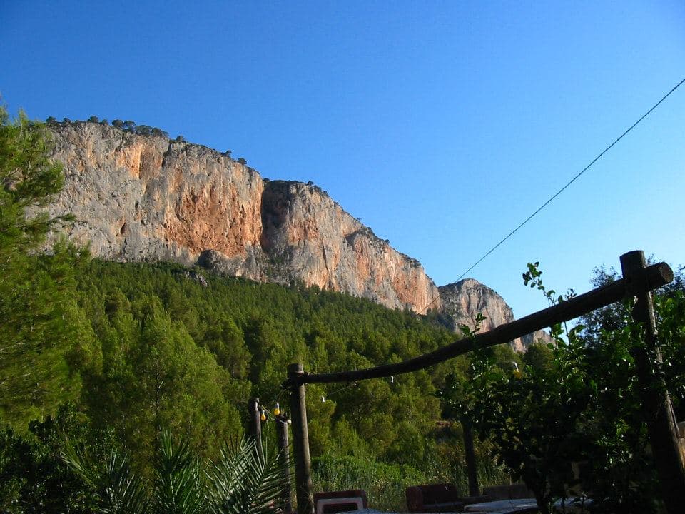 Orange limestone cliffs above the pine forest in Sella, Costa Blanca, Spain – Rockbusters